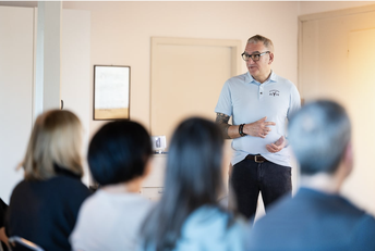 Ayurveda Seminar mit Vortragendem erklärt ganzheitliche Gesundheit und Balance vor einer Gruppe von Teilnehmenden