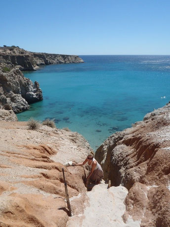 climbing Tsigrado beach, Milos, Cyclades, Greece.