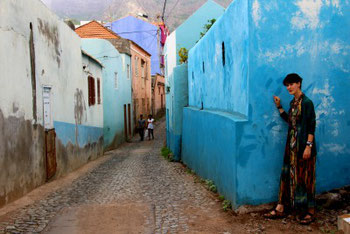 Mia on the corner of a colorful street in the Vila