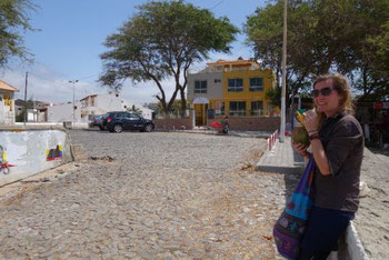 Enjoying fresh coconut water near the beach of Tarrafal, Santiago