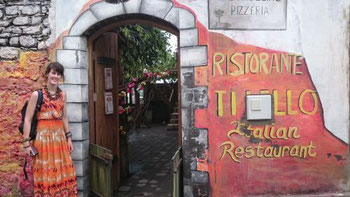 Mia in front of one of the Italian run restaurants