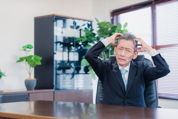 社会保険や労働保険の手続について社長が悩んでいる様子を表したイメージ