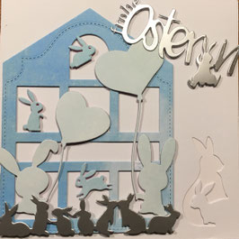 Karte "Frohe Ostern" mit Hasen vor/in hellblauem Haus