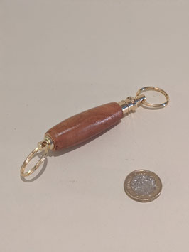 33. Wooden and gilt double ended keyring.