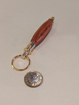 121.  Hardwood and gilt keyring.