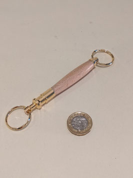 154. Double ended wood and gilt keyring