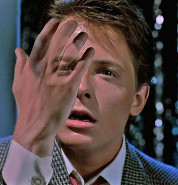 Image of Time Traveler Marty McFly starting to disappear.    Image is from the 1985 movie Back to the Future.