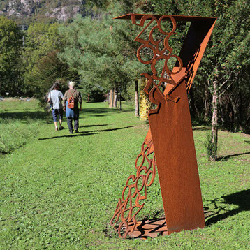 Outdoor sculpture by Paolo Grassi with pink tubular arms and numerical perforations.