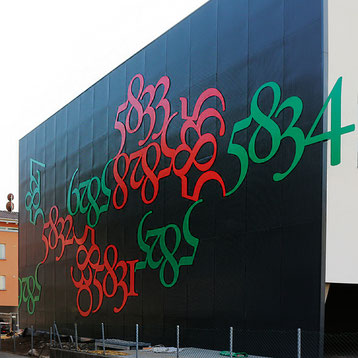 Public sculpture by Paolo Grassi titled Fortis, vertical corten steel installation with numeric elements in Bellinzona.