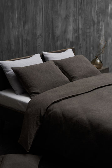 Stack of pillows with brown linen pillowcases by Genix Home