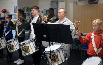 Corps members learning to play whilst marching
