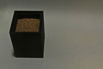 Caja Órgano, 2014. Caja doble de madera pintada de negro, que contiene un mecanismo que hace vibrar a las piedras situadas en el receptáculo superior. 12 x 9 x 9 cm.