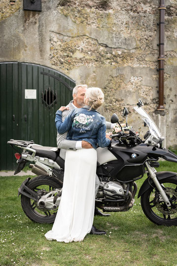 stoere bruid met motor en bedrukt spijkerjasje rock bride