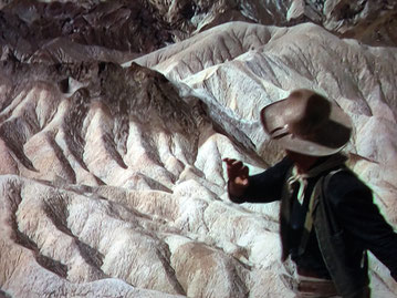 John Wayne throws the empty waterbag down the hill from Zabriskie Point, in Death Valley. 