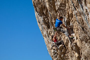 Me, pushing Jack (the north face face) Geldard up a 7c+. Photo by Neil Mawson.