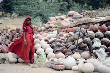 Indian old man selling water-jug.