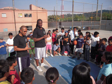 mynor & george teaching at a basketball camp in 2009