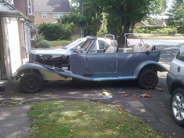 Rear wings fitted, leather seats sitting in the car