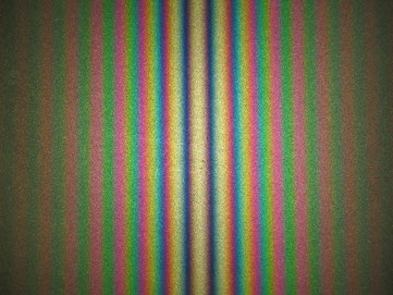 Figure 6. Fringe pattern produced with a Michelson interferometer using white light. As configured here, the central fringe is white rather than black.