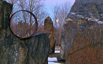 The full 'Worm' moon, setting behind the stone circle at Distant Hill Gardens in Walpole New Hampshire.