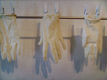 1x Handschuhe, gepudert (Ausschnitt), 2007, Einmalhandschuhe, Latex, Alurohr, Wäscheklammern