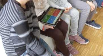 group of students with a tablet