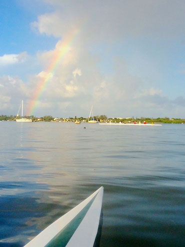 A view off the stern of a 4+ shows the 8+ on flat water with Manasota Key in the background