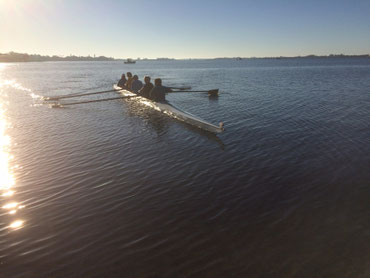 standing on shore as a four approaches