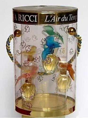 BOÎTE TRANSPARENTE FORME TAMBOUR COMPRENANT : 5 MINIATURES EAU DE TOILETTE, AVEC BOUCHONS COLOMBES, COULEURS DIFFERENTES