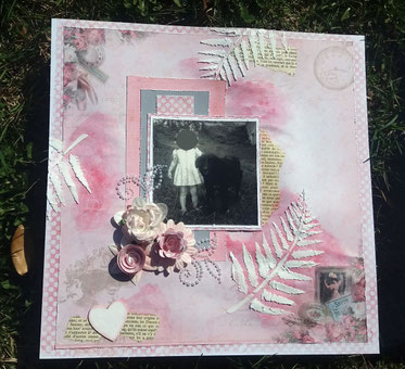 Page de scrapbooking en 30X30 cms, photo en noir et blanc représentant une petite fille et son chien. La page a été encrée avec des encres de couleurs roses du journal déchiré collé dessus, des feuile de fougères en relief en  pâte de structure au pochoir