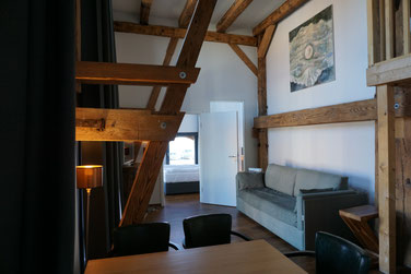 living with view to the water of the sound in the the duplex suite Querkanal of the hotel Hafenspeicher in Stralsund