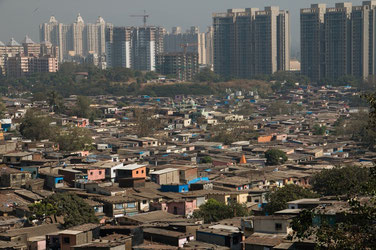 Dharavi Slum with the Shanty Houses and Skyscrapers in the Background, Image: "El Mundo En un Mochila (Translation::The World in a Backpack"). Wordpress.com, Dec.13,2012