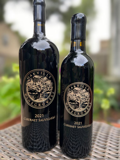Image of two 750ml bottles of the Oakville Cuvee showing front and back etched labels