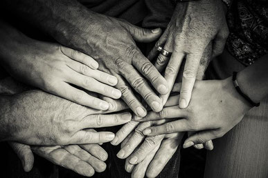 Hände einer Familie liegen übereinander