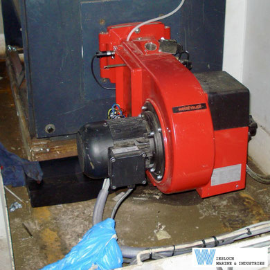 Weishaupt burner for a hot water heating system, showing the Weishaupt burner motor, Siemens RAR9 flame sensor and closing casing with clear sight glass.