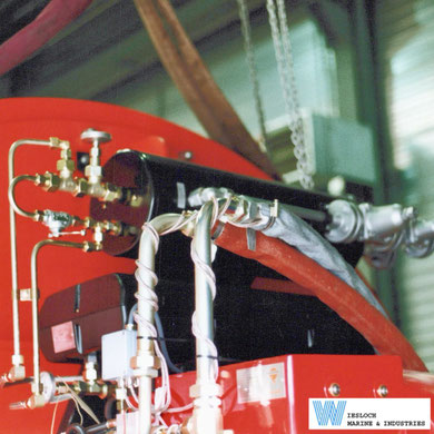 Weishaupt burner installed on a Wiesloch thermal fluid heater, showing two oil preheaters mounted above the burner.