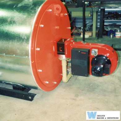 Weishaupt burner installed on a Wiesloch thermal fluid heater, showing the burner control with its cover fitted on the left side and the Weishaupt burner motor on the right side.