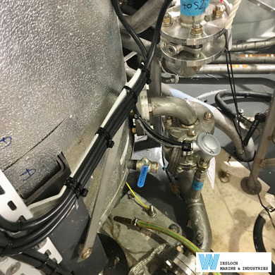 A PT100 temperature sensor installed in the piping of a ship.