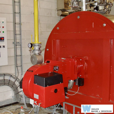 Weishaupt gas burner installed on a heater in an industrial plant.