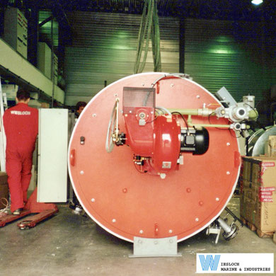 Weishaupt burner installed on a Wiesloch thermal fluid heater, showing oil hoses and the Weishaupt burner motor.