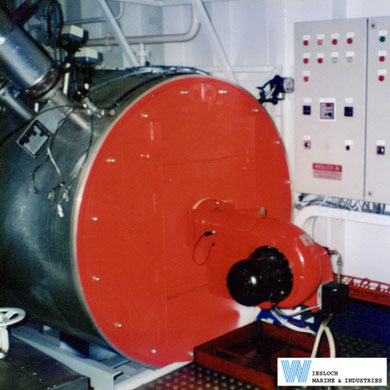 Weishaupt burner installed on a Wiesloch thermal fluid heater, with a Wiesloch control panel and temperature controller visible in the background. Photograph taken in the 1990s.