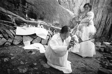 Hi-ah Park salutes the spirits at Mt. Samgak, as her godmother recites invocations