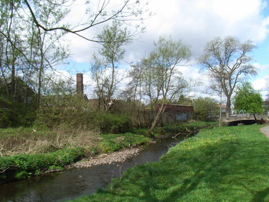 The buildings on the left were the remains of Dogpool Mill - they have since been demolished. The River Rea here is flowing away from the photographer towards the City Centre