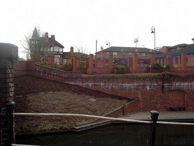 The bridge just in sight on the left of the photographs carries Garrison Lane over the Grand Union Canal. The houses and shops are in Gray Street.  The pub on the left is The Sportsman.