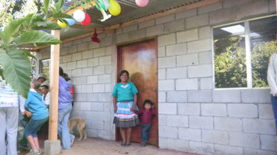 elisia & francisco jr in front of their new home