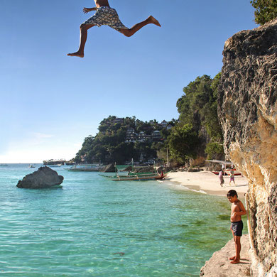 Fearless kids! Cliff Diving from the rocks between White Beach and Diniwid Beach. Boracay, Philippines. 2013 © Sabrina Iovino | JustOneWayTicket.com