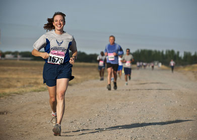 Woman running race looking happy