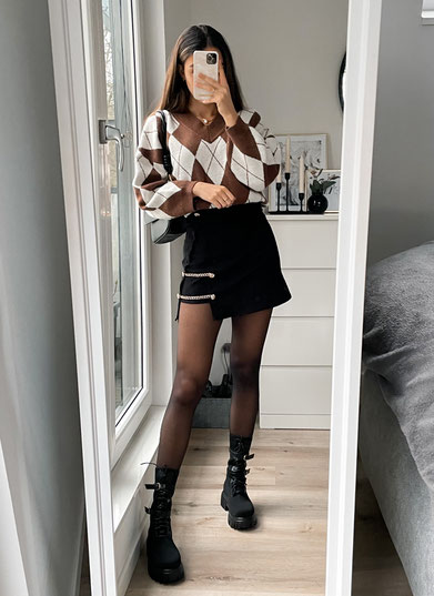 Winter outfit inspiration by sweetinstabella. tights outfit for winter with black ankle/combat boots from Shein, black mini skirt with chain and an oversized brown and white sweater from Shein