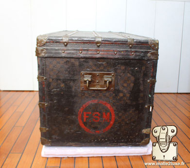 Louis Vuitton initials on an old checkered trunk