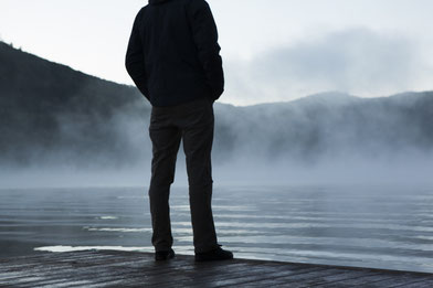 Man is thinking by a lake